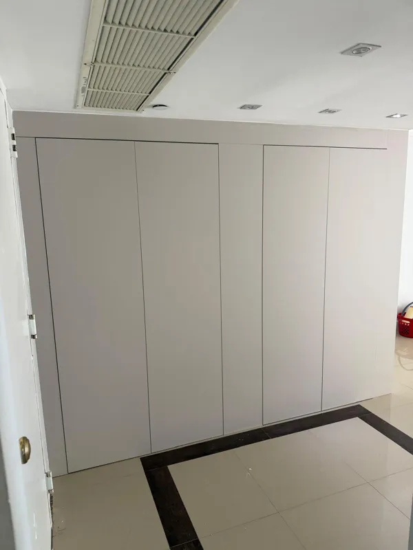 Flush-panel storage wall that hides laundry and linen